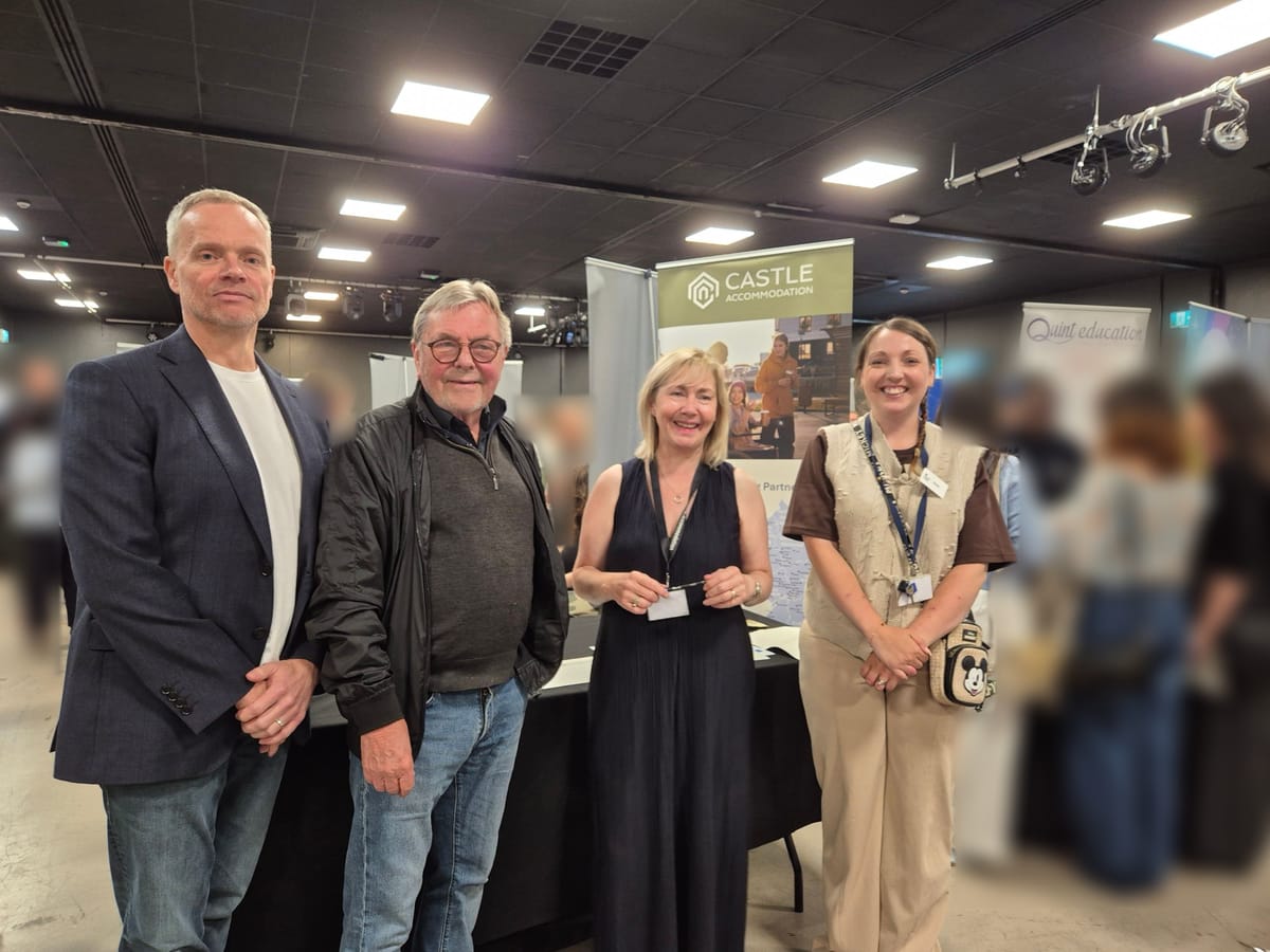 Members of the Castle Accommodation team at a jobs fair, in front of the company’s stand