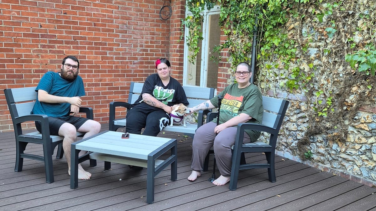 Julie Grantham with her two grown-up children in the garden